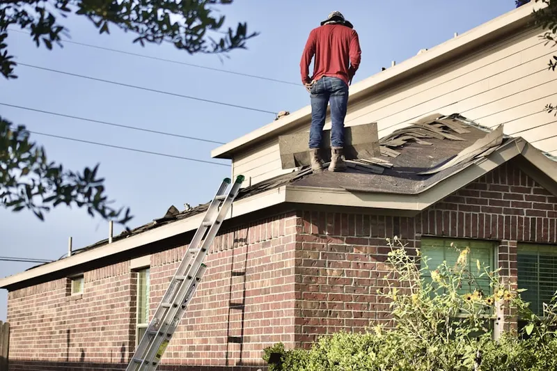 Professional roofer working on a residential roof in San Elizario